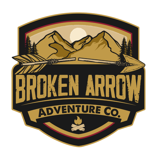 Broken Arrow Adventure Co. original mountain and crossed arrows badge logo on transparent background